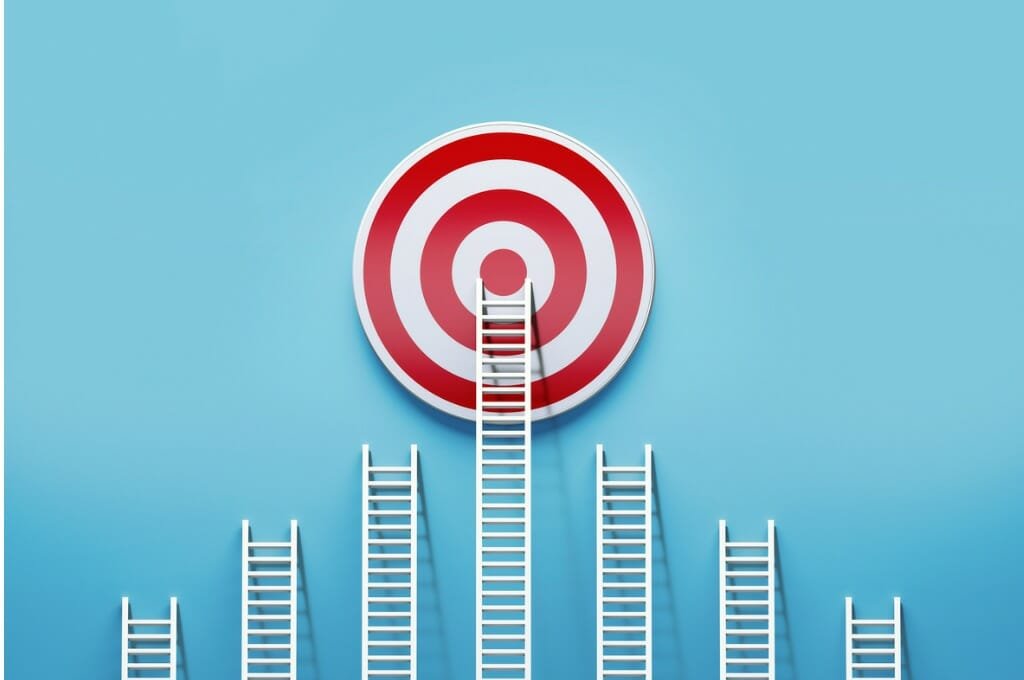 white ladders leaning on a target on blue wall picture id1160035888